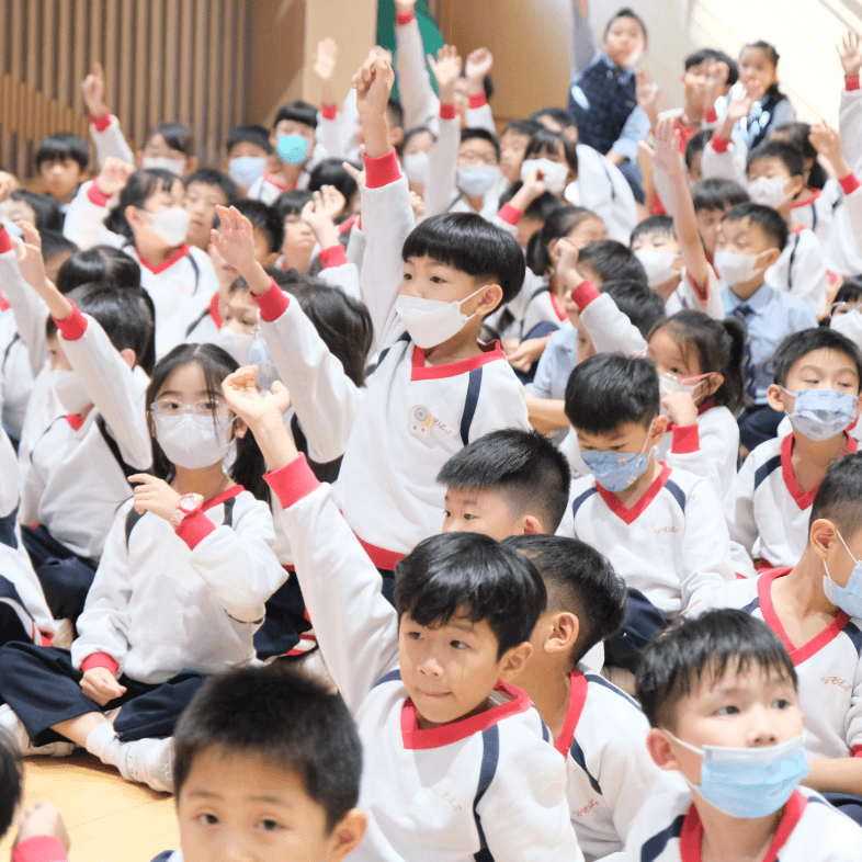 a connect young students raising hands