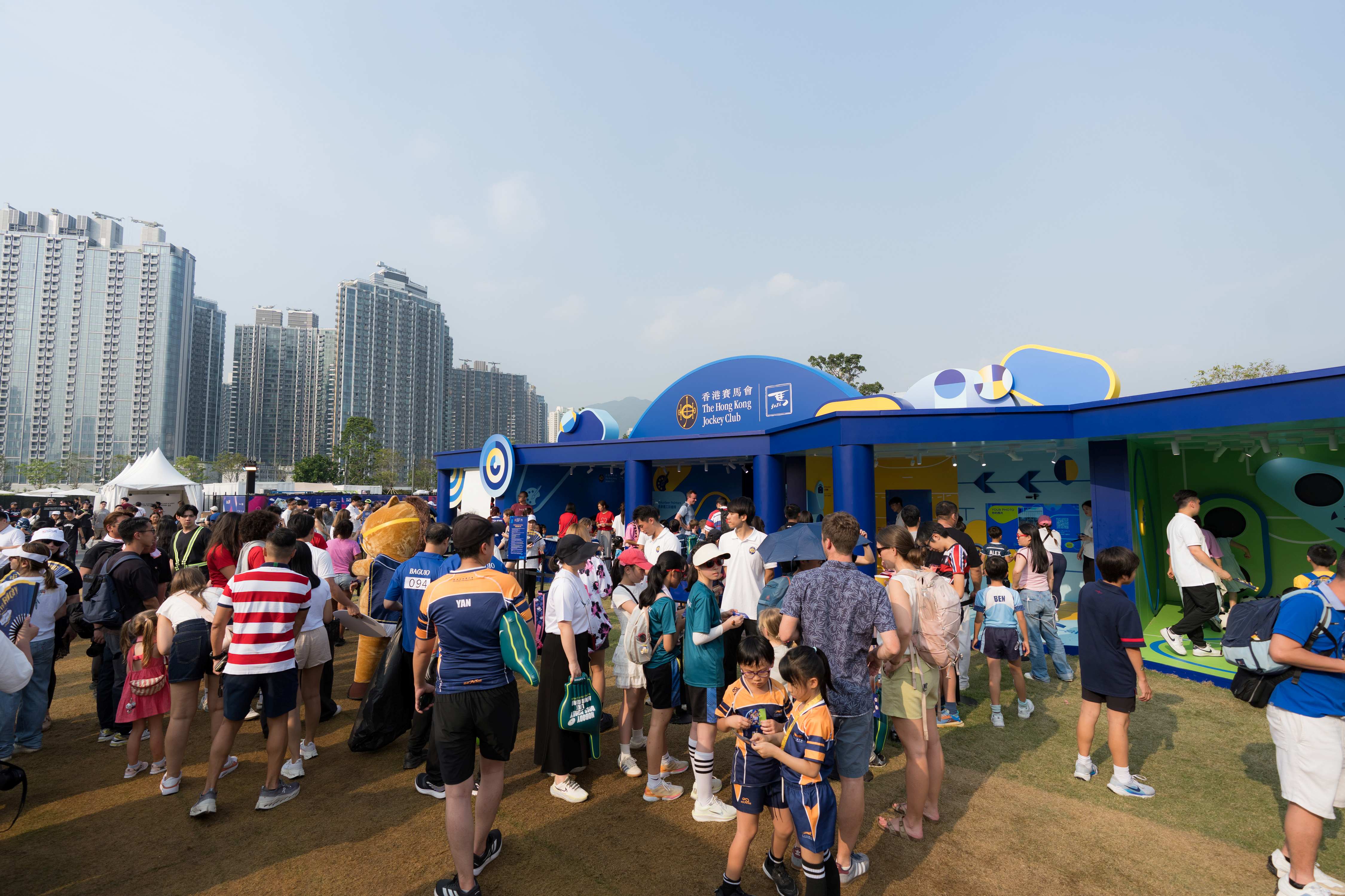 Visitors gather at the Hong Kong Jockey Club booth in the Hong Kong Sevens fan village.