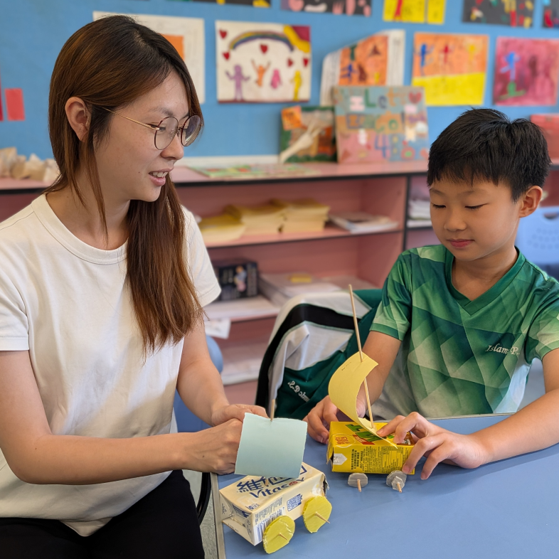 Ms Yuen and Chan Ngo-hei are doing an experiment in a classroom.