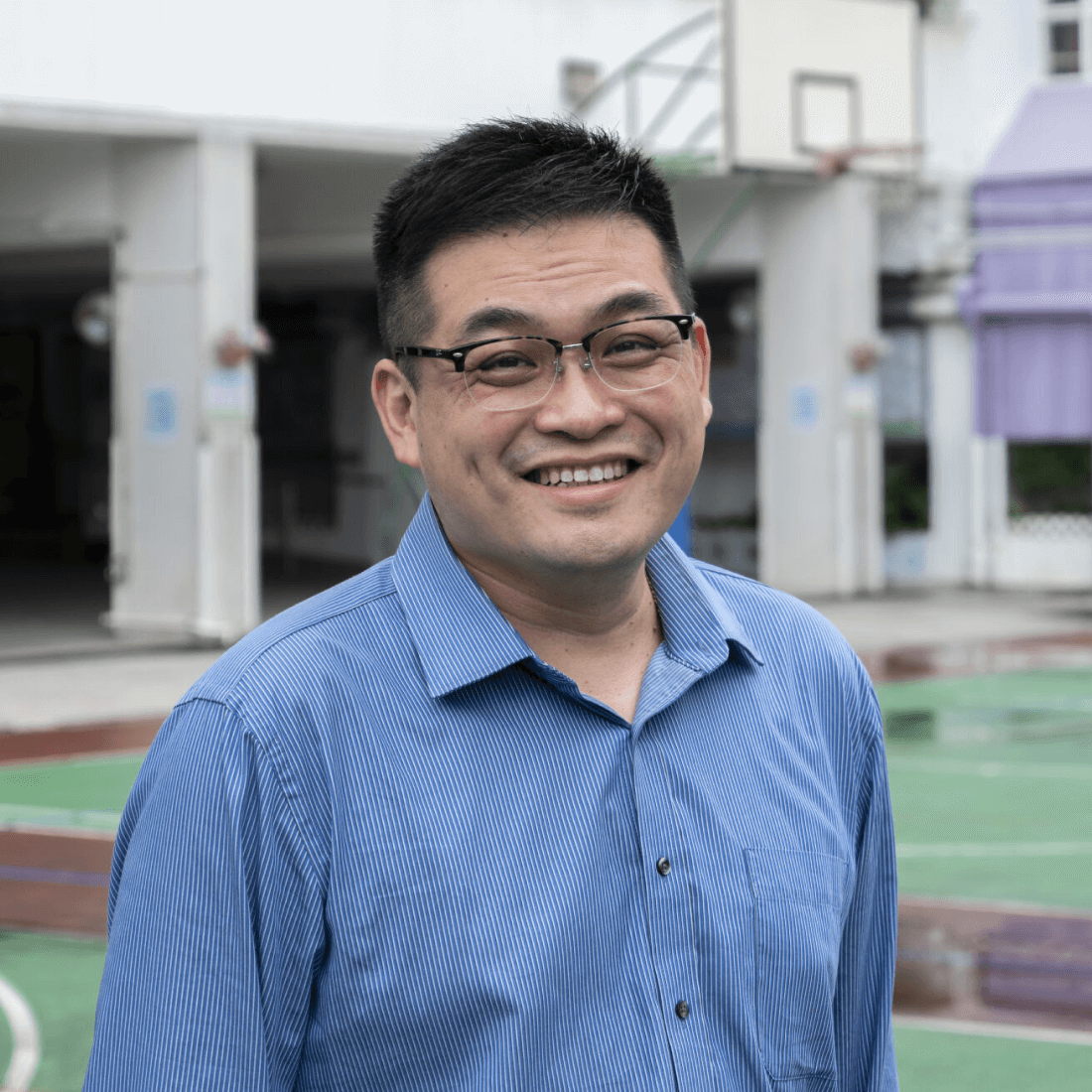 man in blue shirt smiling at camera