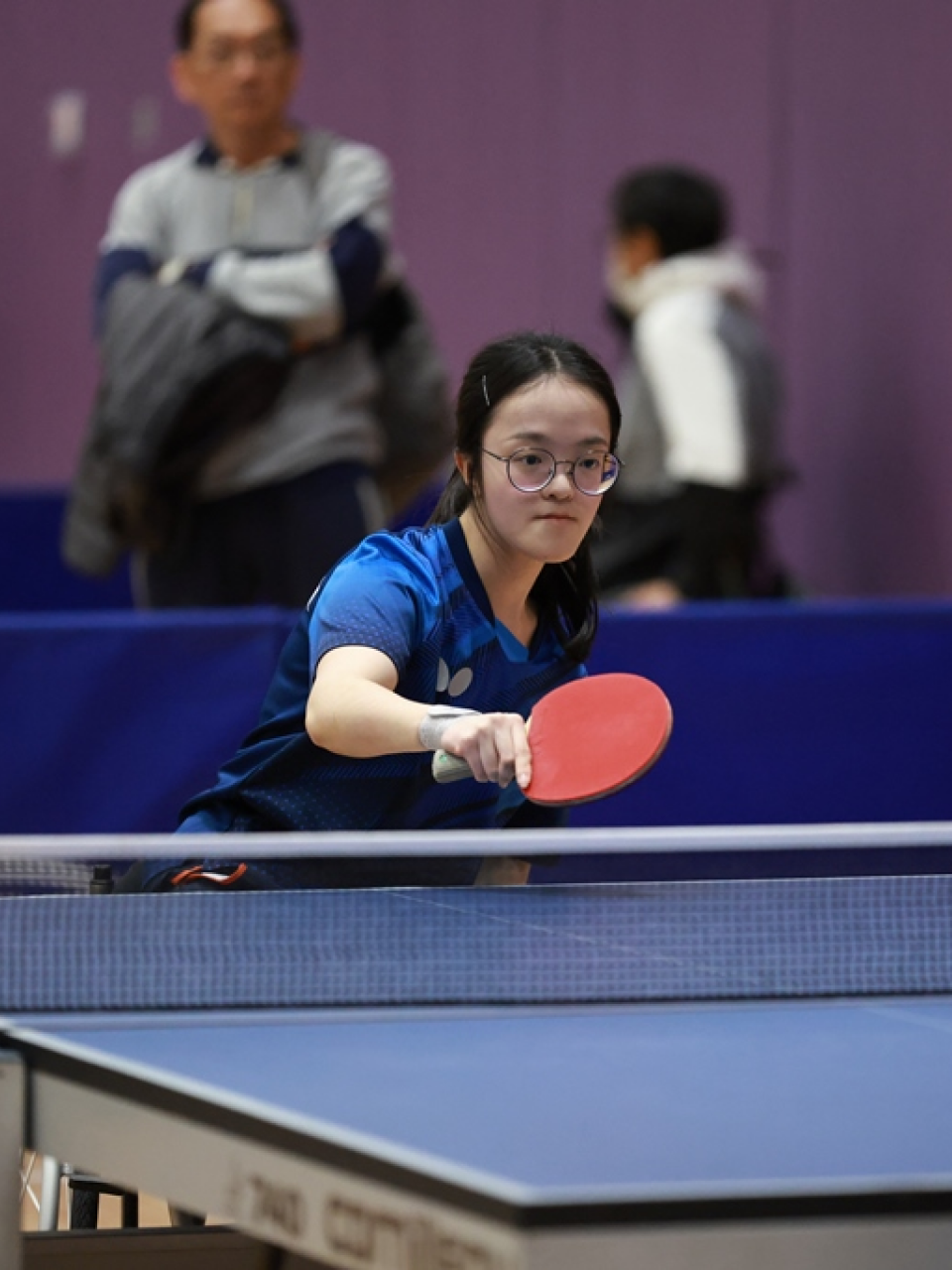 Athlete Yuen Wing-ki stays focused in a table tennis contest.